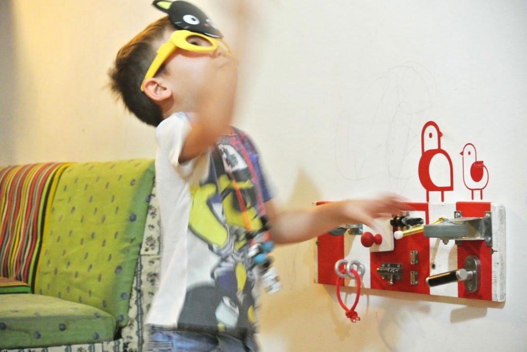 big kid playing with busy board